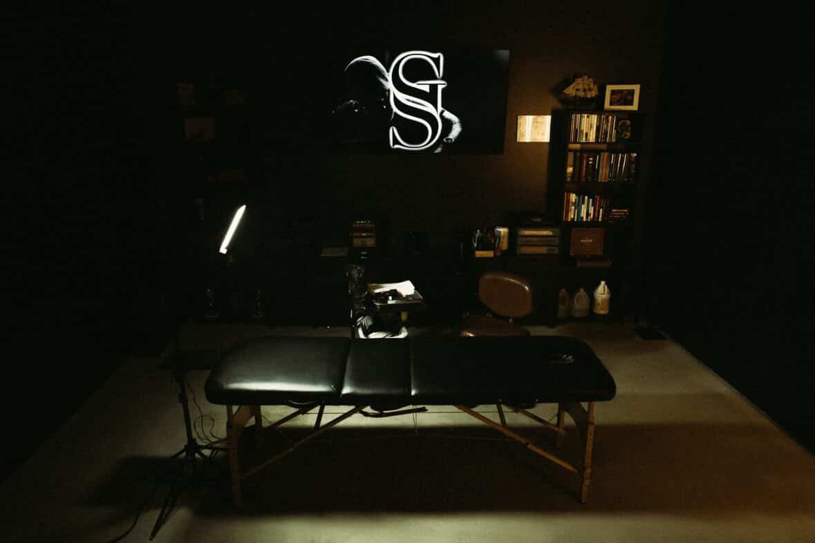 Tattoo bed and work area beneath the Sir George monogram