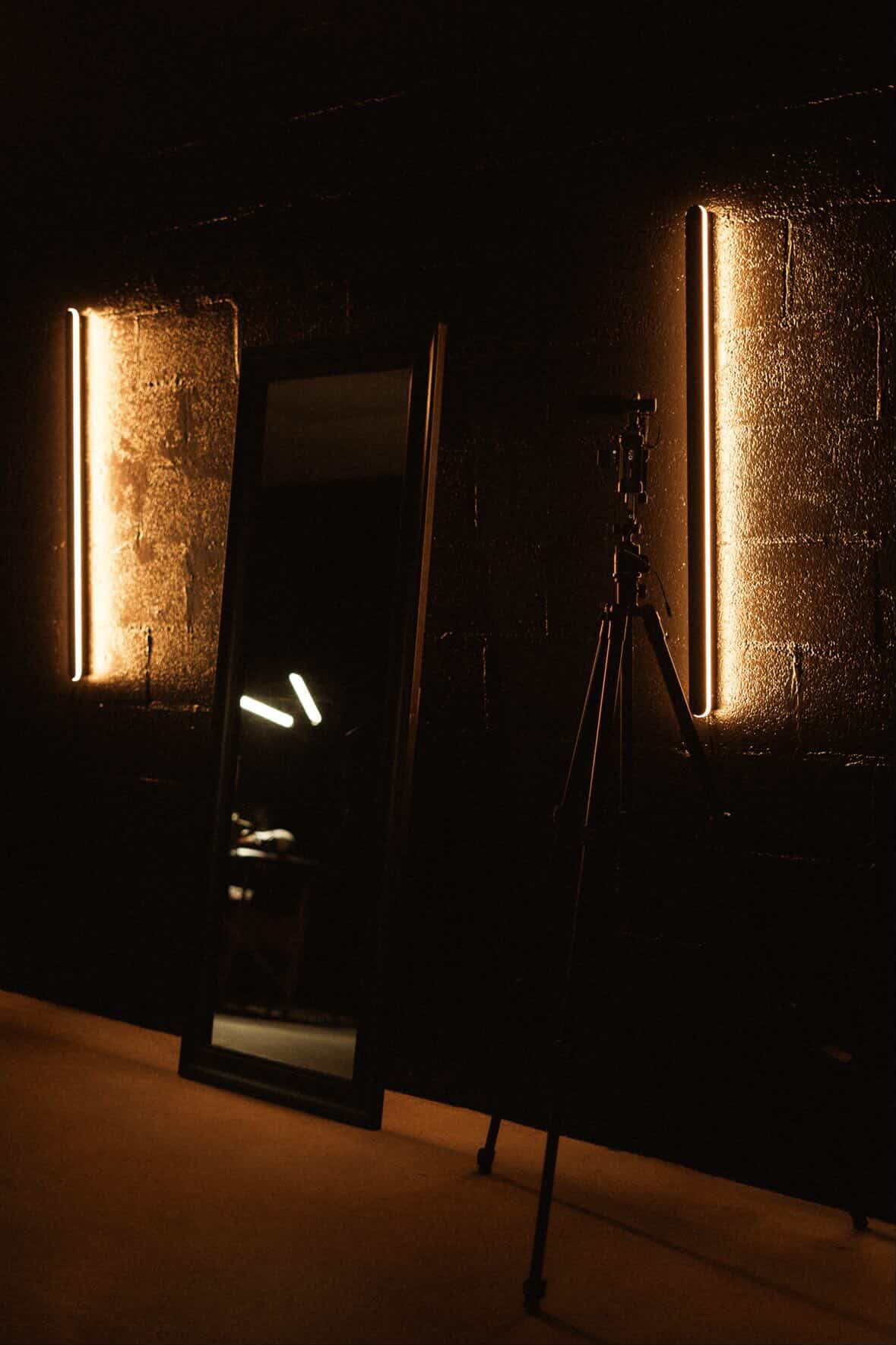 Full-length mirror and warm wall lighting